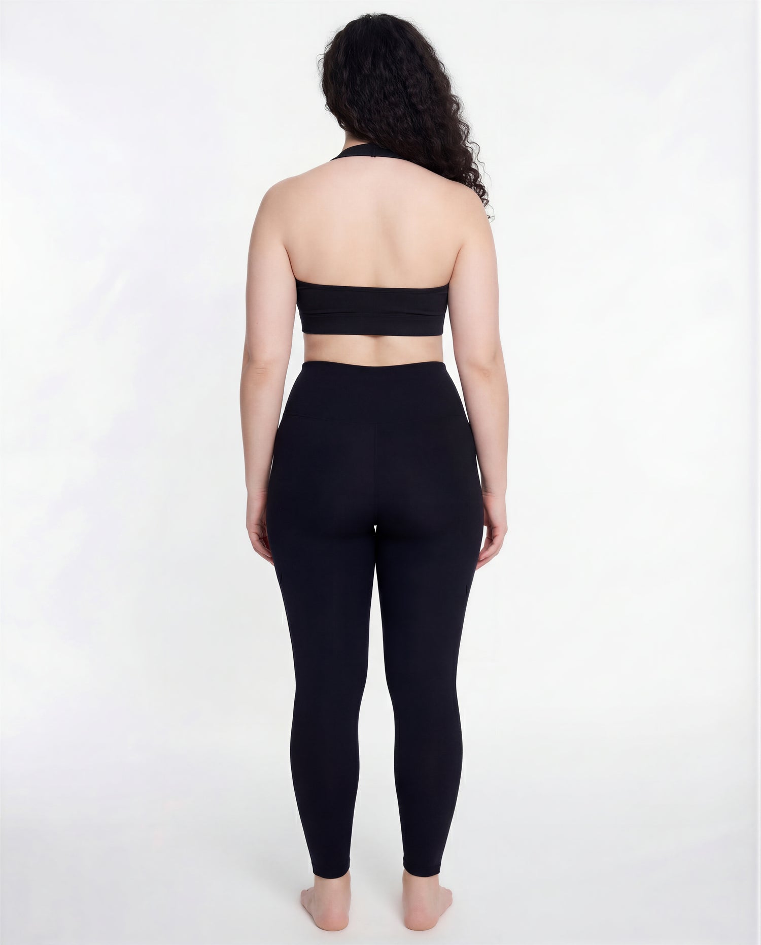 Full back view of the LOAR black seamless leggings, highlighting the contoured fit. Premium alternative activewear.