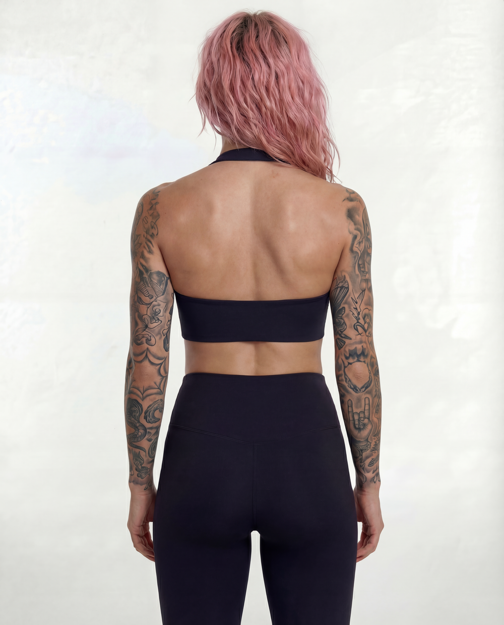 Full back view of the LOAR black Halo Flex Halter and seamless leggings, showcasing the open-back design and high-waisted fit. Premium alternative activewear.