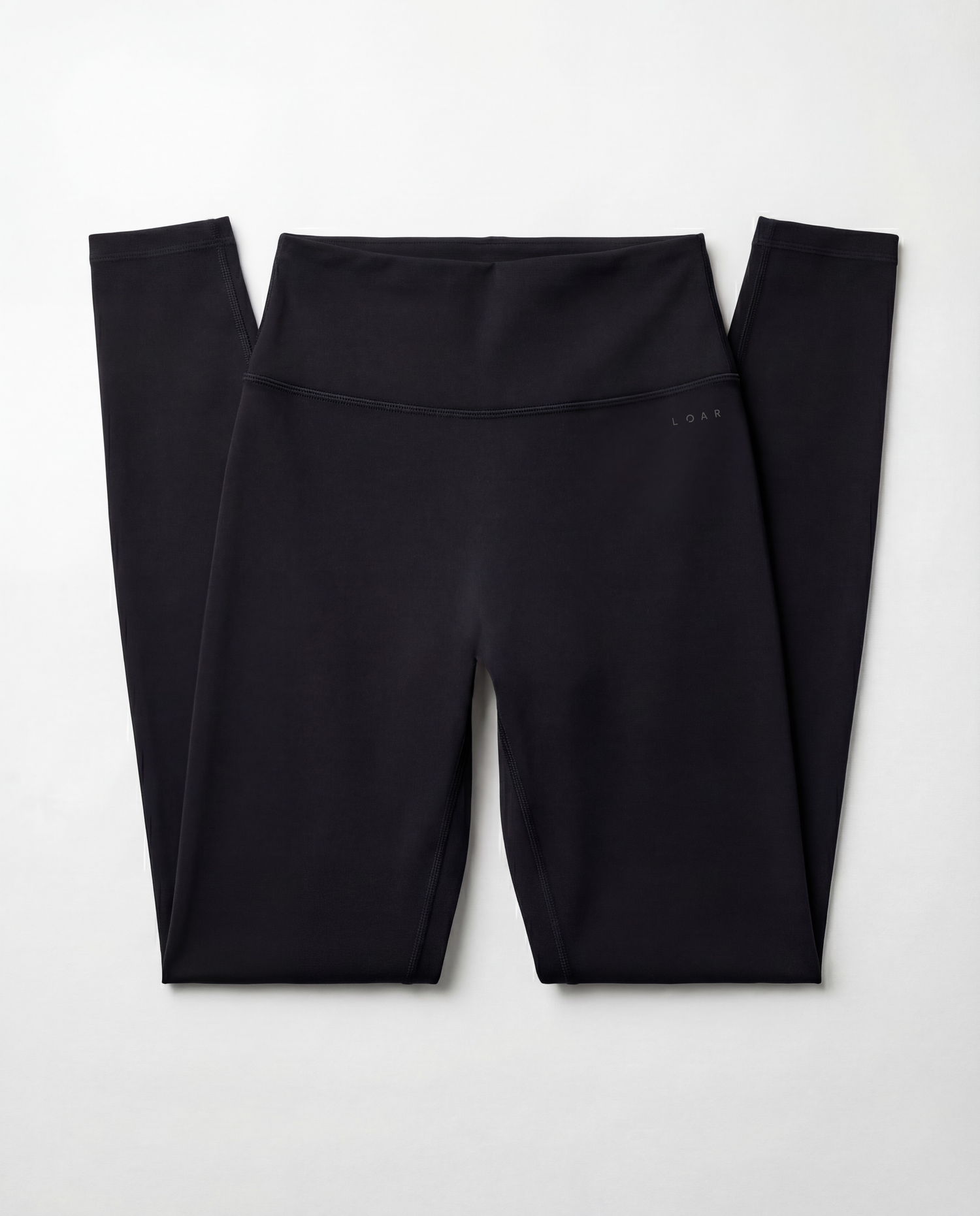 Front flat lay view of the LOAR black seamless leggings, highlighting the high-waisted design. Premium alternative activewear.