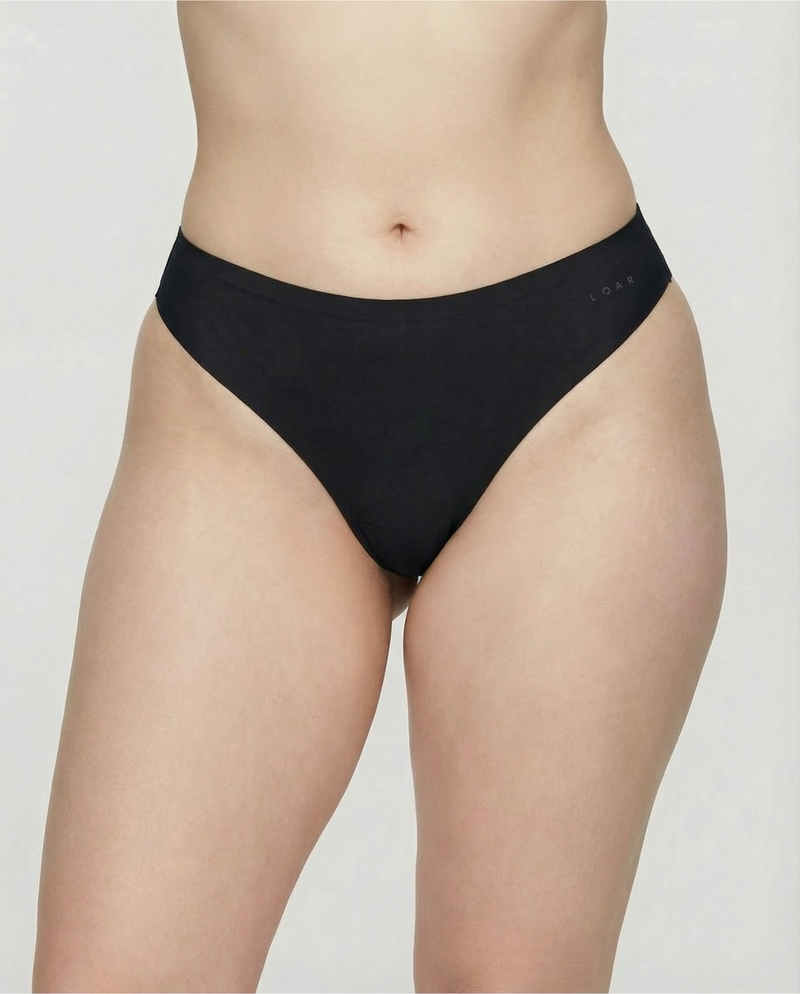Front view of the LOAR black seamless thong, featuring an anti-camel toe design for a flawless fit. Premium alternative activewear.